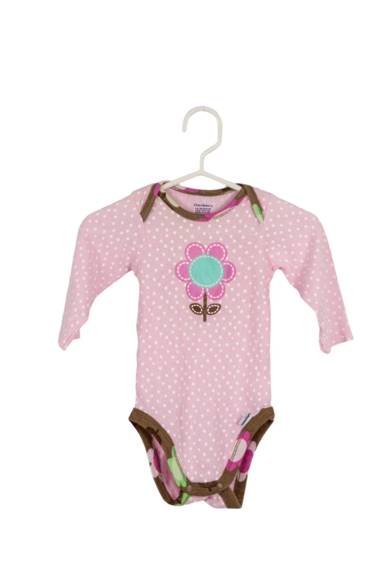 Body Gerber rosado 3 meses con flor en el pecho.